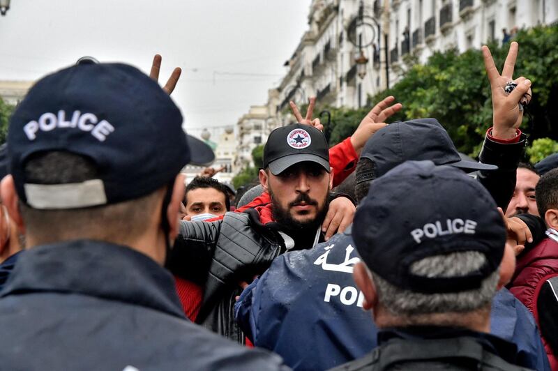 Algerians gesture during a demonstration in the capital Algiers, marking the second anniversary of the rise of the country’s anti-government Hirak protest movement. Police were in force on the streets of the city, and helicopters hovered overhead as checkpoints created traffic jams. AFP