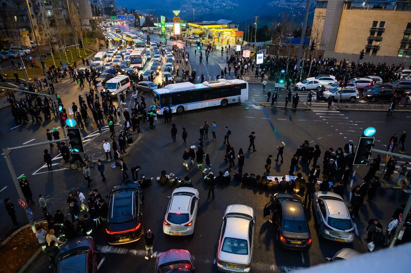 Ultra-Orthodox Jewish boys and men block traffic in and out of Jerusalem in protest against the expiration of a law exempting them from being drafted into the Israeli army. Getty Images