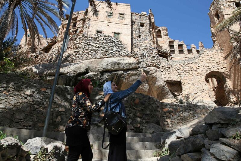 Egyptian tourists take a selfie as they tour the village of Misfat Al Abriyeen on the escarpments of Oman's Grand Canyon. AFP
