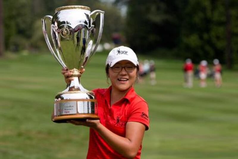 15-year-old Lydia Ko celebrates with the Canadian Women's Open trophy after winning in Vancouver.