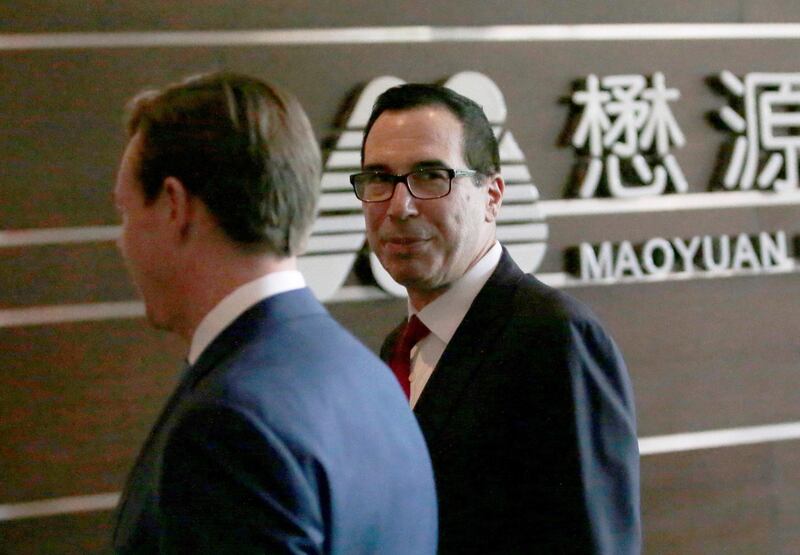 FILE PHOTO: U.S. Treasury Secretary Steven Mnuchin (R) is seen as he and a U.S. delegation for trade talks with China arrive at a hotel in Beijing, China May 3, 2018.  REUTERS/Jason Lee/File Photo