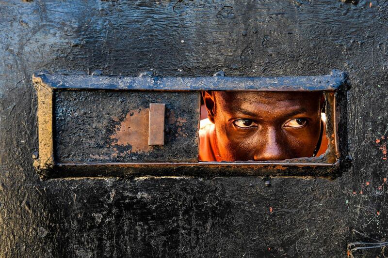 A man looks inside the Orphanage of the Church of Bible Understanding where a fire broke out the previous night in the Kenscoff area outside of Port-au-Prince.  AFP