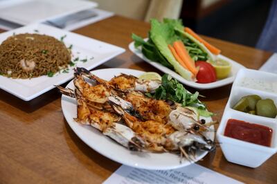 The grilled seafood dishes are popular at Bu Tafish. Khushnum Bhandari / The National
