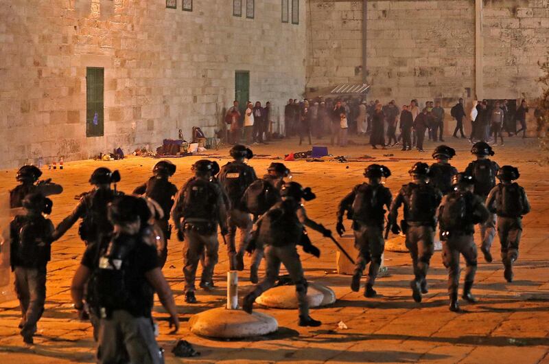 Israeli security forces advance during clashes with Palestinian protesters at the compound that includes Al Aqsa Mosque, in Jerusalem, on Friday, May 7, 2021. AFP