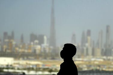 A man stands at a racetrack overlooking Dubai following the UAE's decision to postpone the Dubai World Cup on March 23. AFP