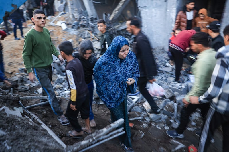 Palestinians assess the damage after an Israeli strike in Rafah. AFP