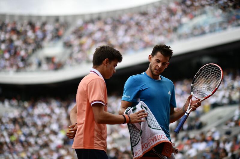 A ballboy gives a towel to Thiem. AFP