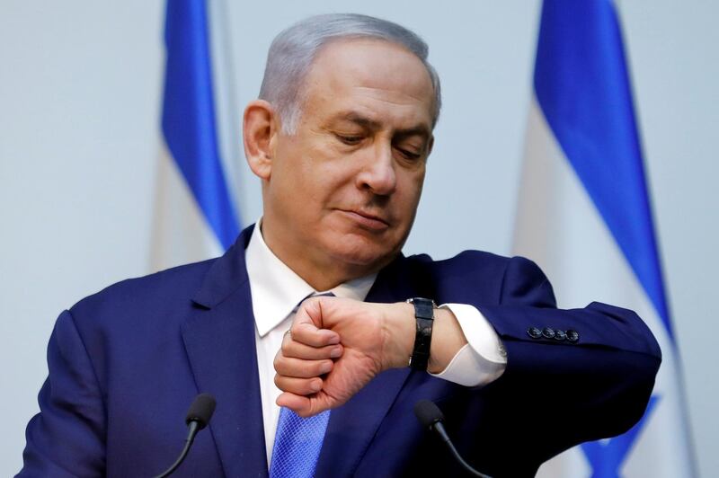 FILE PHOTO: Israeli Prime Minister Benjamin Netanyahu looks at his watch before delivering a statement at the Knesset, Israel's parliament, in Jerusalem December 19, 2018. REUTERS/Amir Cohen/File Photo
