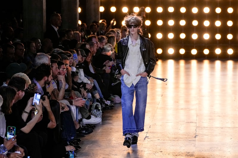 At the show, Celine designer Hedi Slimane sent out a line-up of bare-chested models in sheer, unzipped tops and dazzling blazers, marking the return of French label to Paris Fashion Week's menswear shows. AP