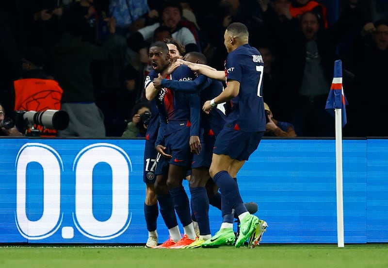PSG players celebrate with Ousmane Dembele after his equalising goal against Barcelona. Reuters