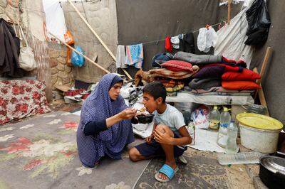 Displaced Palestinians, who fled their house due to Israel's military offensive shelter in a tent, in Rafah. Reuters