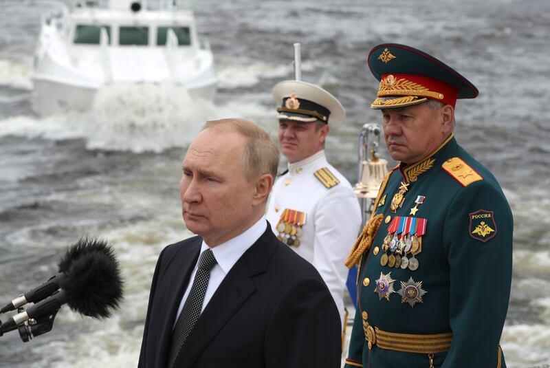 Russian President Vladimir Putin and Russian Defence Minister Sergey Shoigu, right. British military sources claim the defence minister is out of favour with Kremlin leadership. EPA