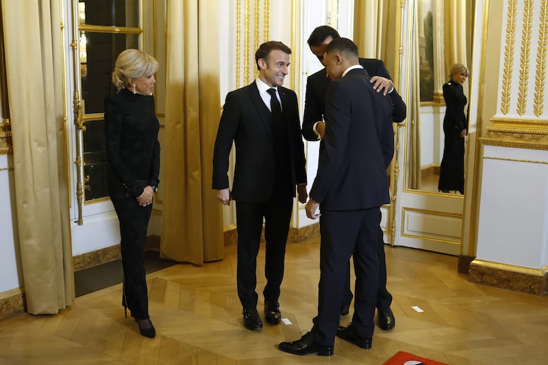 Sheikh Tamim is pleased to greet Mbappe as Mr Macron and his wife watch on. EPA