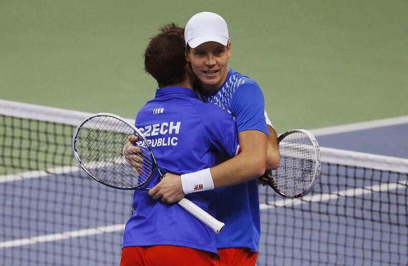 Tomas Berdych, right, and Radek Stepanek embrace after winning their doubles match on Saturday to put the Czech Republic 2-1 up on Serbia in the Davis Cup final. Marko Djurica / Reuters