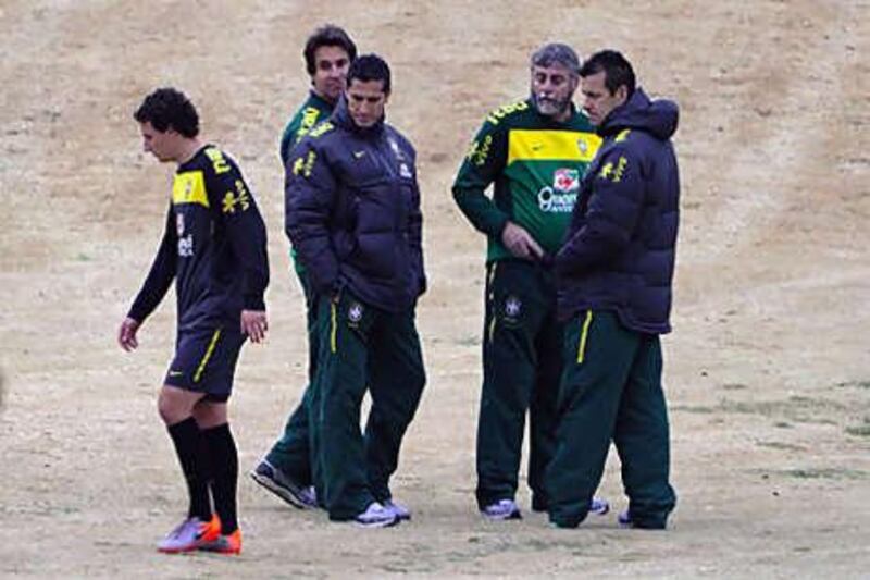 Dunga, right, the Brazil coach, and the team's technical staff watch as Elano, left, limps off a training session on Tuesday.