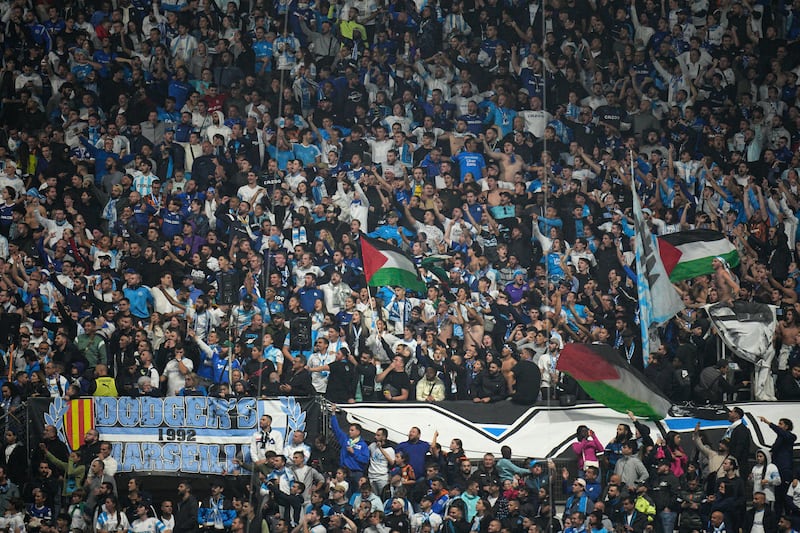 Marseille fans wait for the start of the French Ligue 1 match against Lyon at Stade Velodrome. The match was eventually postponed at Lyon's request. AP