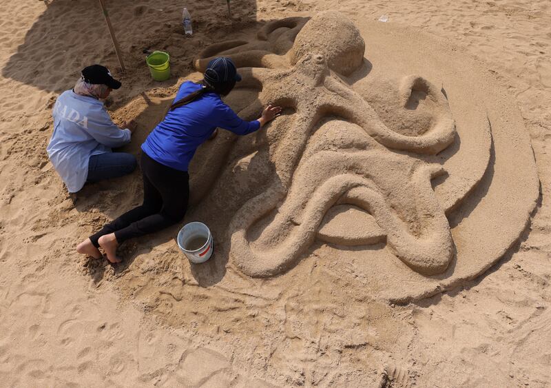 Fine arts students Dina Badr and Tasniem Ibrahim, with 'Shape of Octopus', during the Alexandria Sand Sculpture Festival