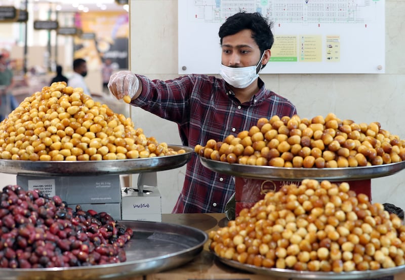 Vendor Ali Malbari perfects his display at Souq Al Jubail Seventh Annual Dates Festival.