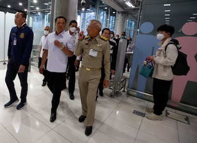 Thai Transport Minister Saksayam Chidchob , Health Minister Anutin Charnvirakul and Tourism and Sports Minister Phiphat Ratchakitprakarn at Bangkok Airport after welcoming the first flight of Chinese tourists arriving in Samut Prakan province. EPA