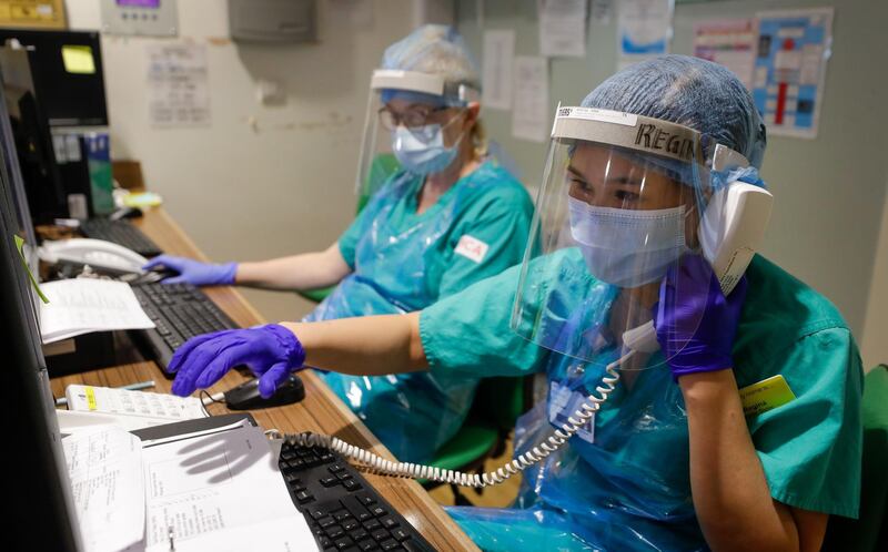 Nursing staff wearing protective face masks, shields and gloves work on a ward during a TACTIC-R trial at the Addenbrooke's Hospital, operated by the Cambridge University Hospital NHS Foundation Trust, in Cambridge, U.K., on Thursday, May 21, 2020. The new trial known as TACTIC-R is testing whether existing drugs will help prevent the body's immune system from overreacting, which scientists hope could prevent organ failure and death in Covid-19 patients. Photographer: Kirsty Wigglesworth/AP Images/Bloomberg