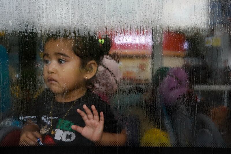 A girl evacuated from Sudan looks through the window of a bus after arriving in Jakarta, Indonesia. Reuters