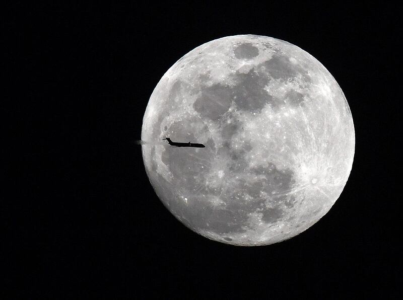 Jan 30, 2018; Senoia, GA, USA; Delta flight 1789 a MD-90 aircraft from Atlanta to Jacksonville transits across the super moon over the evening sky in Georgia. A rare celestial phenomenon when a super moon, blue moon and total lunar eclipse will take place at the same time in the early morning hours of Jan 31st. Mandatory Credit: John David Mercer-USA TODAY Sports     TPX IMAGES OF THE DAY