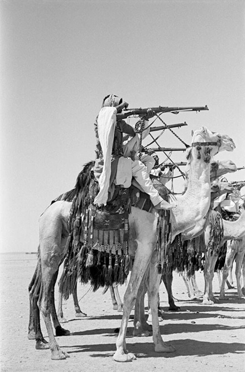 Desert Patrol on manoeuvres in the desert at Al-Mafraq. The Camel Corps were the original "Glubb's Girls". Recruited from Bedouin Arabs, they wore their hair in long ringlets, wore long-skirted robes and darkened their eyes with khol, 1952.  Photo: George Rodger