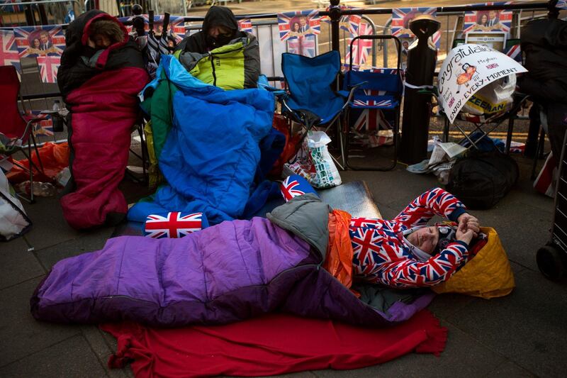 A man sleeps on the ground. Emilio Morenatti / AP Photo