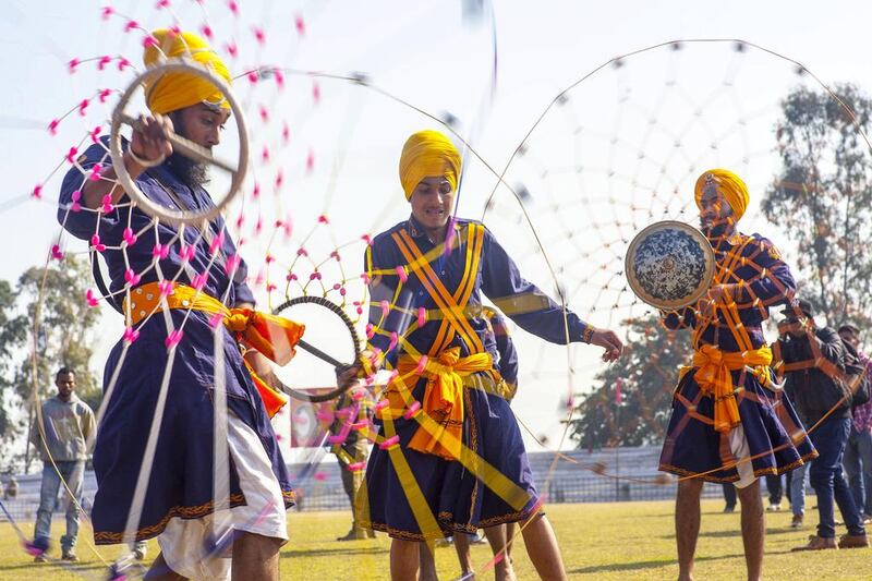 Nihang Sikh monks demonstrate their fighting skills at the festival.