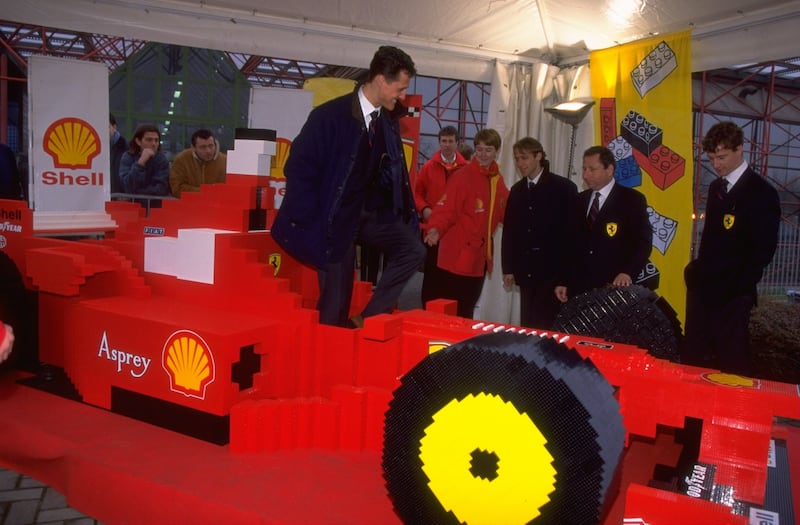 Ferrari Formula One driver Michael Schumacher of Germany tries out the Lego Ferrari at the launch of the new 1998 F300 Ferrari in Maranello, Italy. Allsport