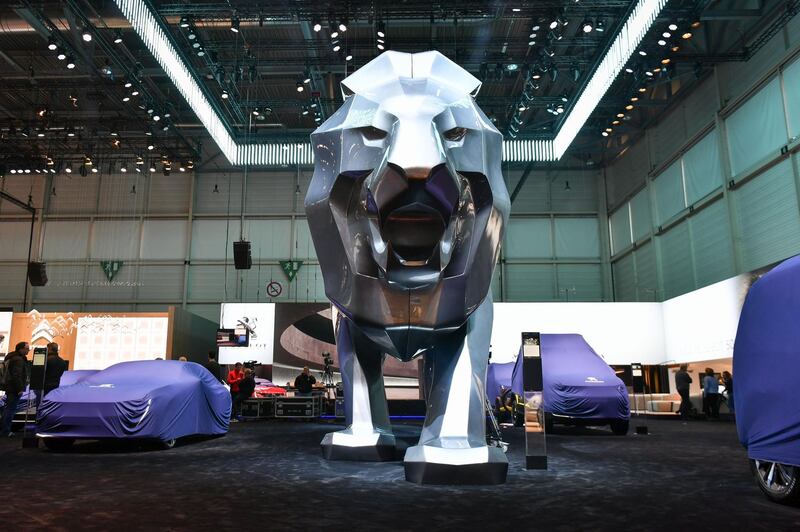 A picture taken on March 5, 2018 in Geneva shows covered cars a the stand of French carmaker Peugeot ahead of the start of the Geneva International Motor Show 2018. 
This year's Geneva Motor Show comes at a curious time for an auto world enjoying record profits yet also gripped by doubt midway through the grand transition from diesel to electric and self-driving vehicles. / AFP PHOTO / Harold Cunningham