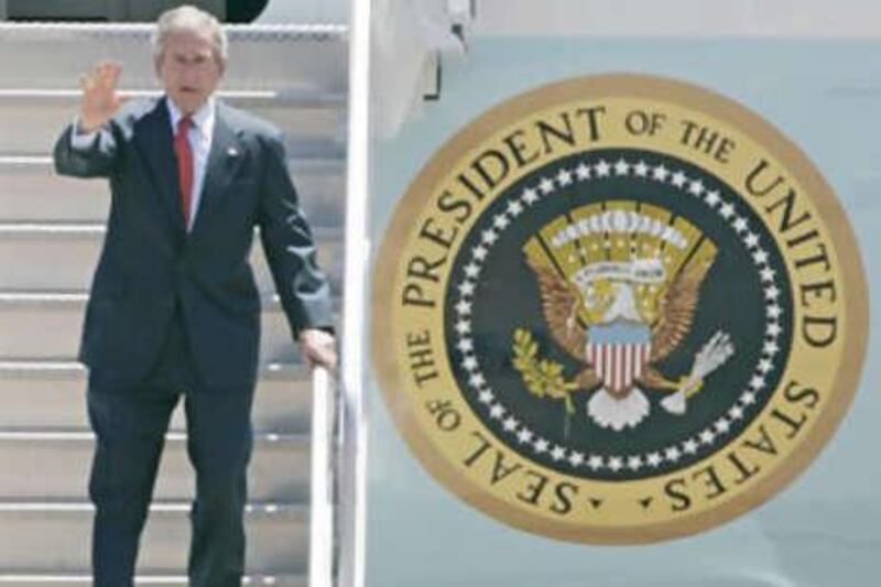 President George W Bush waves as he disembarks Air Force One. As he prepares to leave the White House media speculation over Iran threatens to boil over.