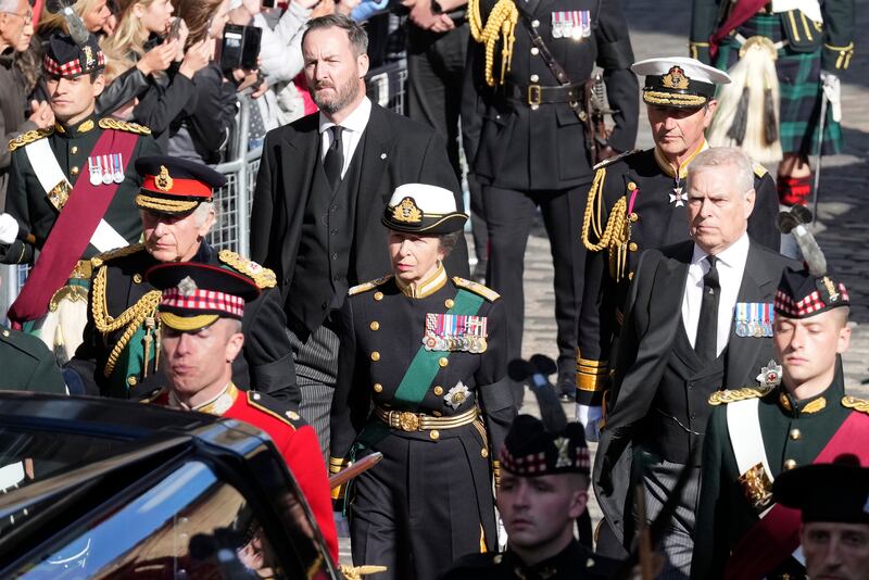 Prince Andrew and his siblings walk behind the hearse carrying Queen Elizabeth II's coffin as it moves along the Royal Mile during the procession from Palace of Holyroodhouse to St Giles' Cathedral. Getty Images