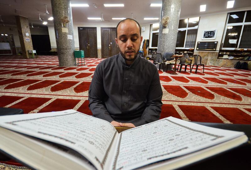 Jordanian imam Eyyas Hajibi reads the Quran inside a mosque in Amman, Jordan. Reuters