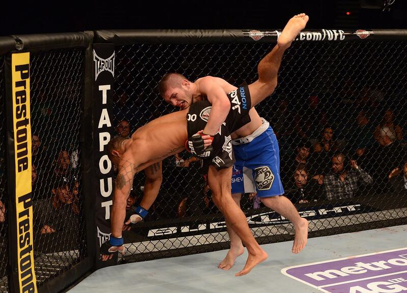 LAS VEGAS, NV - MAY 25:   (R-L) Khabib Nurmagomedov slams Abel Trujillo in their lightweight bout during UFC 160 at the MGM Grand Garden Arena on May 25, 2013 in Las Vegas, Nevada.  (Photo by Donald Miralle/Zuffa LLC/Zuffa LLC via Getty Images)