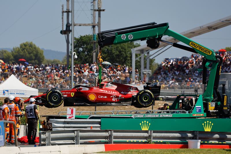 Stewards remove Charles Leclerc's Ferrari after his crash. EPA