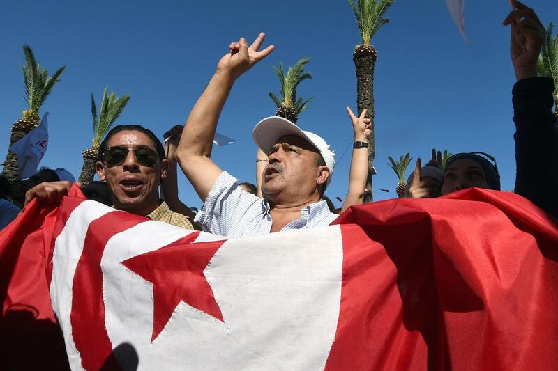 Supporters of Nidaa Tounes (Call for Tunisia) stage a demonstration ahead of the parliamentary election in the coastal city of Hammam Lif, south of Tunis, on October 21. Fethi Belaid / AFP

