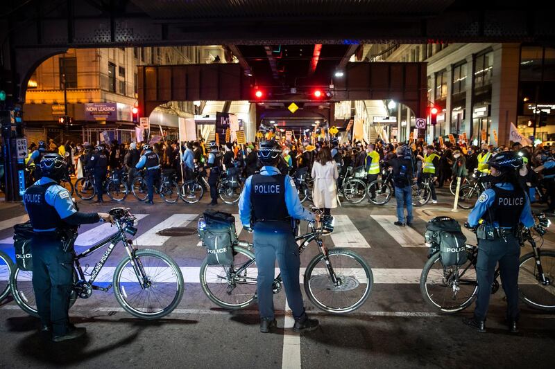 Chicago police officers keep watch as at least 1,000 protesters march through the Loop to demand every vote be counted in the general election, in Chicago, as President Donald Trump tries to stop the effort in key battleground states. AP