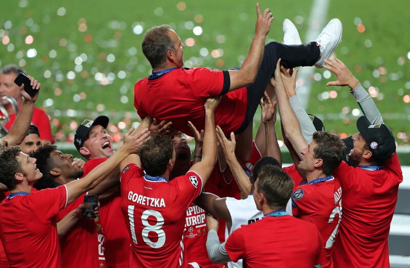Bayern's head coach Hans-Dieter Flick is tossed in the air. AP