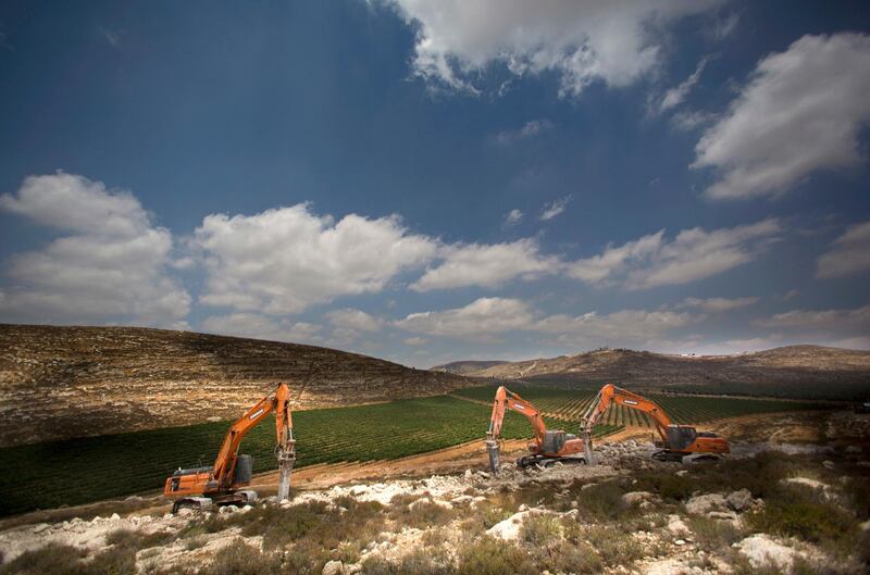 FILE - In this June 21, 2017 file photo, diggers break ground for a new settlement near the Israeli settlement of Shilo, in the West Bank. Israeli Defense Minister Avigdor Lieberman said Thursday, May 24, 2018, that he will seek approval next week to fast-track construction of 2,500 new West Bank settlement homes this year and advance 1,400 more units that are currently in the planning stage. Senior Palestinian official Hanan Ashrawi condemned Liebermanâ€™s announcement as â€œIsraeli colonialism, expansionism and lawlessnessâ€ and called on the International Criminal Court in The Hague, Netherlands, to launch an investigation. (AP Photo/Dusan Vranic, File)
