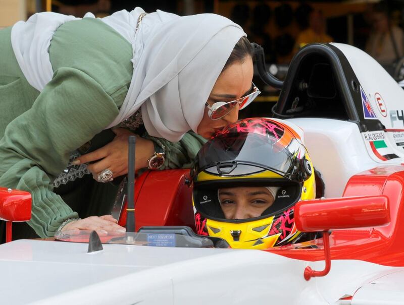 Hamda Al Qubaisi receives a kiss on the helmet from her mother, Kawthar, ahead of the race. Victor Besa / The National