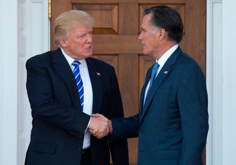 (FILES) In this file photo taken on November 19, 2016 US President-elect Donald Trump shakes hands with Mitt Romney after their meeting at the clubhouse of Trump National Golf Club in Bedminster, New Jersey. Incoming Senator Mitt Romney issued harsh criticism of President Donald Trump on January 1, 2019, saying he "has not risen to the mantle of the office." / AFP / Don EMMERT
