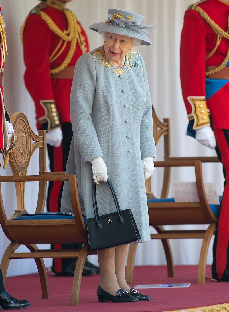 Queen Elizabeth II, in light blue, attends a military ceremony in the Quadrangle of Windsor Castle to mark her official birthday at Windsor Castle on June 12, 2021. Getty Images