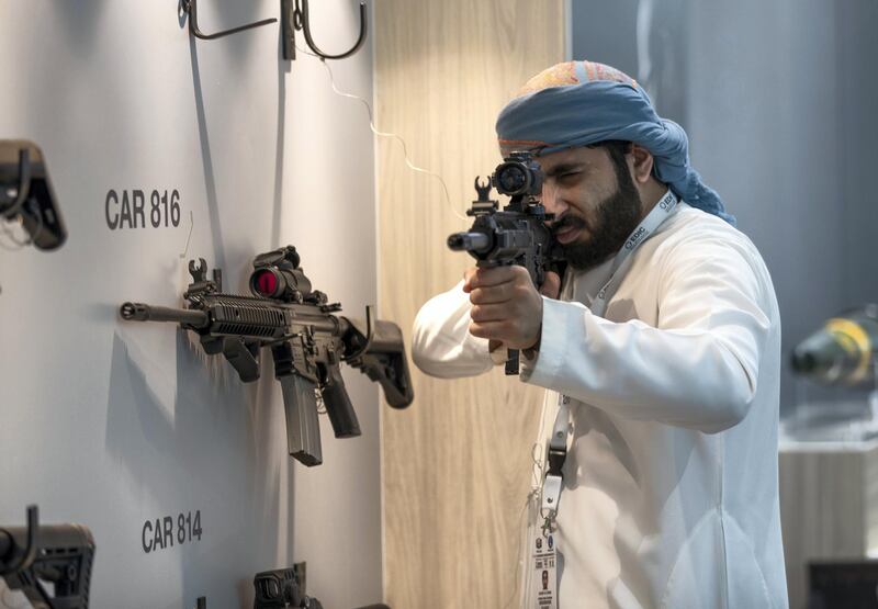 Abu Dhabi, U.A.E., February 18, 2019. INTERNATIONAL DEFENCE EXHIBITION AND CONFERENCE  2019 (IDEX) Day 2--  
  A exhibition visitor handles one of the Caracal CAR 816 Assault Rifles at the Caracal stalls.
Victor Besa/The National
