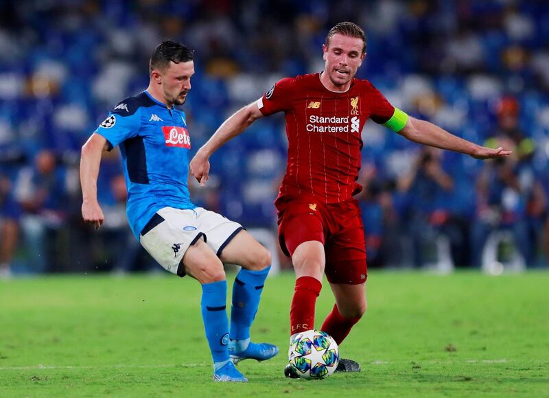 Liverpool's Jordan Henderson in action with Napoli's Mario Rui. Reuters