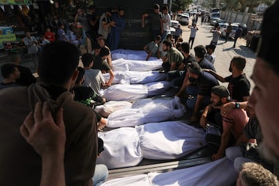 Mourners gather around the bodies of members of the Agha family, killed in an Israeli strike in Khan Younis in the Gaza Strip, on Friday. AFP 