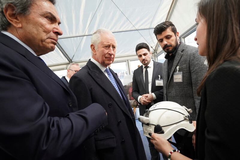 King Charles III is presented with a White Helmet from the Syria Civil Defence organisation as he talks with members of the Syrian diaspora in Trafalgar Square, London. AP