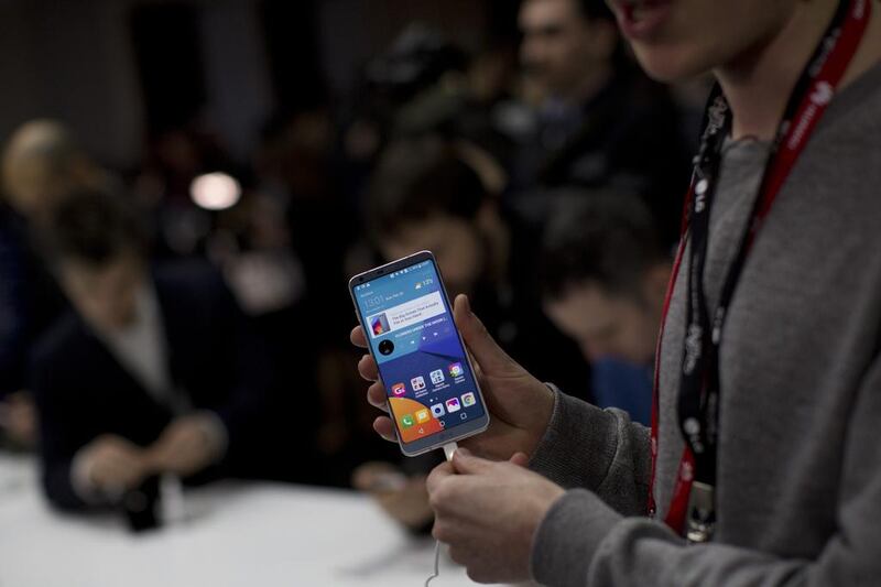 A journalist holds the new G6 unveiled by LG as its next phone, ahead of the Mobile World Congress show. Emilio Morenatti / AP Photo