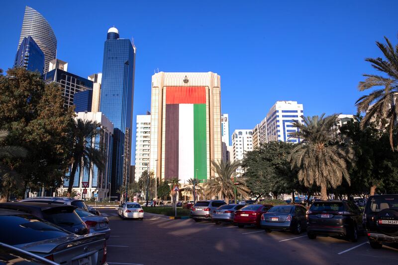 A giant UAE flag adorns the Arab Monetary Fund building on the Corniche in Abu Dhabi. Victor Besa / The National.