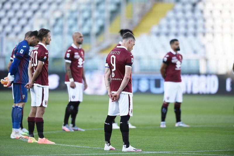 Players observe a minute of silence to honour the victims of coronavirus, prior to the Serie A match between Torino and Parma. AP Photo